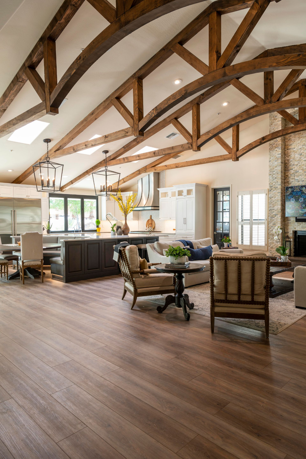 Open-concept kitchen and living room with vaulted ceilings and wood trusses